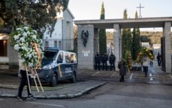 People carry wreaths at Mingorrubio's cemetery, on the outskirts of Madrid, Spain, Oct. 24, 2019, the Spanish dictator Gen. Francisco Franco's new resting place.