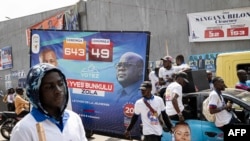 FILE - A picture of the President of the Democratic Republic of the Congo and leader of the Union of Democracy and Social Progress party, Felix Tshisekedi (C), is seen during a campaign in Kinshasa on December 14, 2023. 