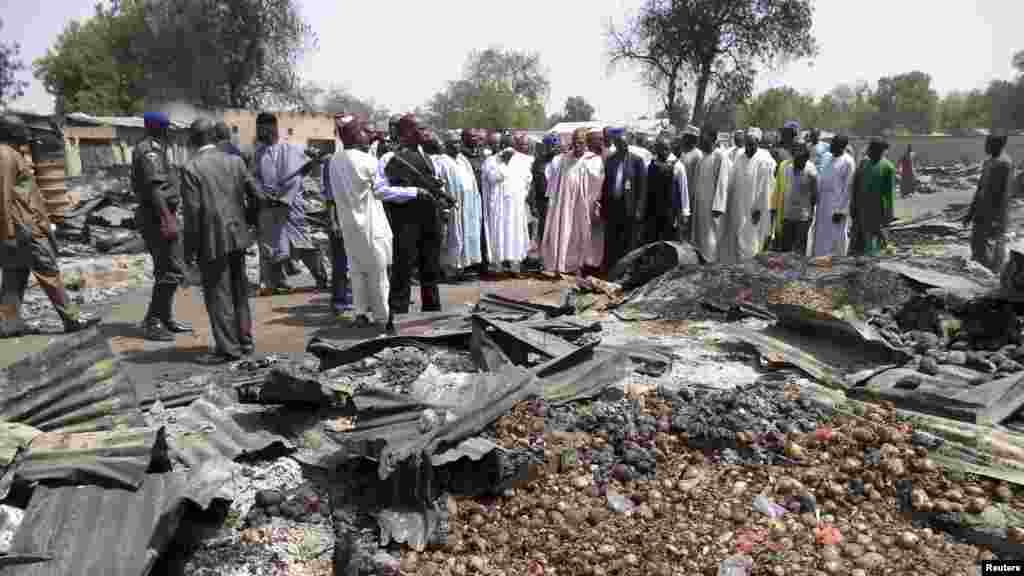 Governor of Borno State Kashim Shettima (C) visits the burnt Bama market destroyed by gunmen last Thursday, in Borno April 29, 2013.