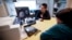 FILE - Patient Alison Cairnes (foreground) looks at images with her doctor Shumei Kato at the University of California San Diego in San Diego, Aug. 15, 2017. 