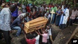 Relatives mourn as the coffin of Florence Masika, who was killed along with her son Zakayo Masereka by suspected rebels as they retreated from Saturday's attack on the Lhubiriha Secondary School, is buried in Nyabugando, Uganda, Sunday, June 18, 2023.