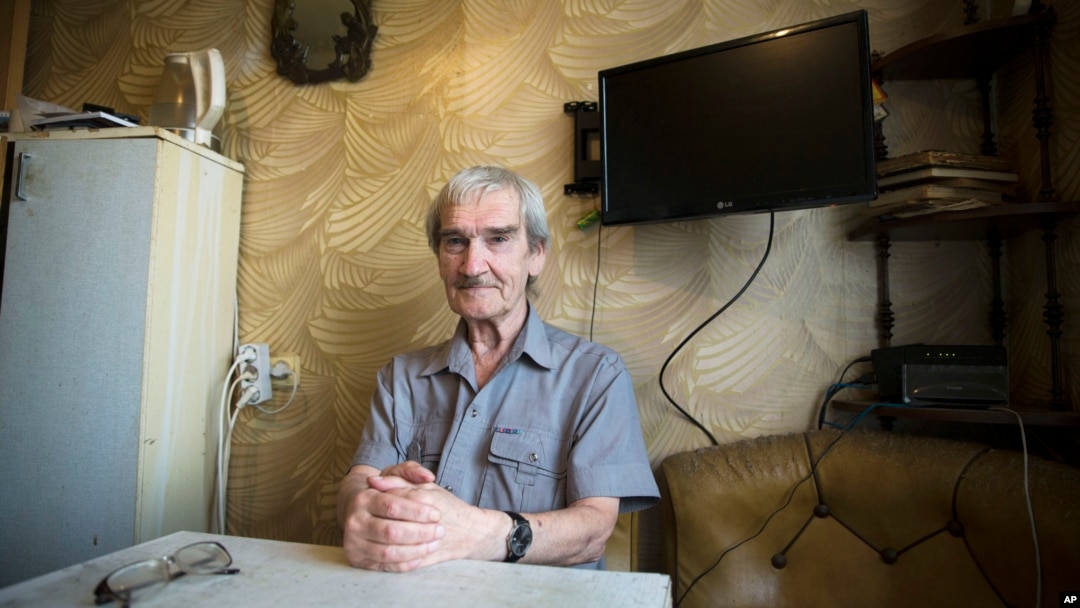 In this Thursday, Aug. 27, 2015 photo former Soviet missile defense forces officer Stanislav Petrov poses for a photo at his home in Fryazino, Moscow region, Russia.