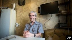 In this Thursday, Aug. 27, 2015 photo former Soviet missile defense forces officer Stanislav Petrov poses for a photo at his home in Fryazino, Moscow region, Russia.