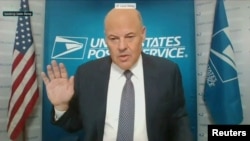 FILE - U.S. Postmaster General Louis DeJoy is sworn in to testify via video feed during a virtual hearing of the U.S. Senate Homeland Security and Governmental Affairs Committee, August 2020.