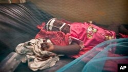 A Somali child with suspected meningitis lies in an isolation ward of the Benadir hospital in Mogadishu, Somalia Wednesday, April 24, 2013. Authorities in Somalia, which has one of the lowest immunization rates in the world, launched the deployment of a pentavalent vaccine against diphtheria, tetanus, whooping cough, hepatitis B, and haemophilus influenzae type B the bacteria that causes meningitis and pneumonia. (AP Photo/Ben Curtis)