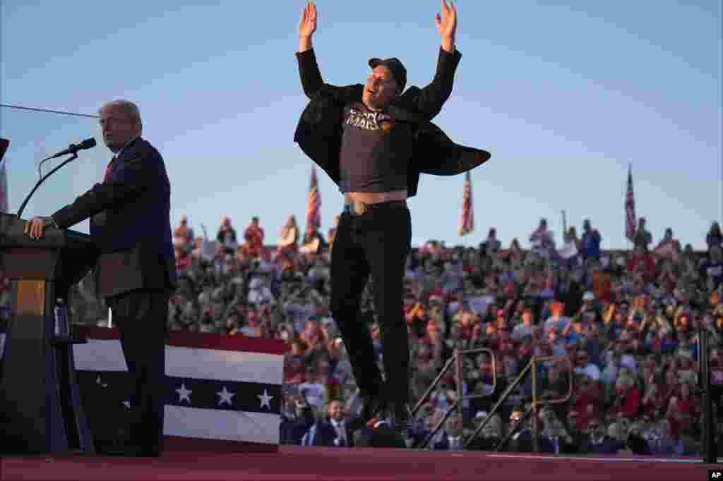 Elon Musk jumps on the stage as Republican presidential nominee former President Donald Trump speaks at a campaign rally at the Butler Farm Show, Oct. 5, 2024, in Butler, Pennsylvania.