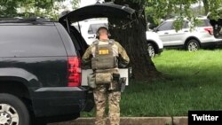 An FBI officer is seen on the site of a shooting in northeastern Maryland. (Credit - @ScottWykoffWBAL)