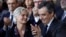 Conservative presidential candidate Francois Fillon applauds while his wife, Penelope, looks on as they attend a campaign meeting in Paris, Jan. 29, 2017. Financial prosecutors are investigating whether the former prime minister's wife was paid for work she didn't do. 