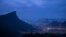 FILE - The Christ the Redeemer statue stands atop the Corcovado Mountain, left, at dawn in Rio de Janeiro, Brazil, July 29, 2016. 