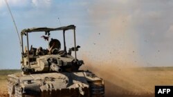 FILE - An Israeli army tank rolls in southern Israel along the border with the Gaza Strip on January 24, 2024, amid ongoing battles between Israel and the Palestinian militant group Hamas. 