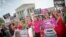 Demonstrator react to hearing the Supreme Court's decision on the Hobby Lobby case outside the Supreme Court in Washington, June 30, 2014. 