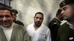 Mohamed Ahmed Hussein aka Mohamed Kammuni, center, along with two other men, has been convicted of killing six Coptic Christians and one policeman, in January 2010 outside a church in the village of Nagaa Hammadi (file photo)