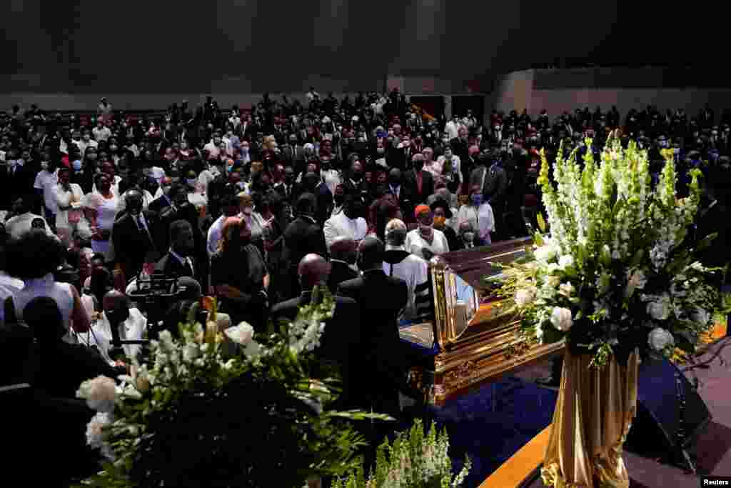 Family members of George Floyd pauses at the casket during a funeral service for Floyd at The Fountain of Praise church, June 9, 2020, in Houston.