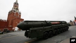 FILE - A nuclear-capable Russian Topol M intercontinental ballistic missile with launch vehicle rolls along Red Square during a military parade, in Moscow, Russia, May 9, 2017.