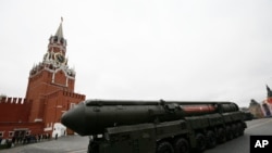 FILE - A nuclear-capable Russian Topol M intercontinental ballistic missile with launch vehicle rolls along Red Square during a military parade, in Moscow, Russia, May 9, 2017.