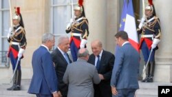 French Foreign Minister Le Drian, welcomes Director of the UN Migration Agency Antonio de Carvalho Ferreira Vitorino, French Interior Minister Christophe Castaner, UN High Commissioner for Refugees, at the Elysee Palace, in Paris, July 22, 2019.