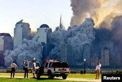 FILE - The remaining tower of New York's World Trade Center, Tower 2, collapses in a cloud of dust and debris Sept. 11, 2001. Some conspiracy theorists believe the towers were demolished by powerful, unknown people or forces.