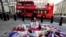 PETA supporters dressed in bear masks and covered in bloody "arrow wounds" lie on a Union Jack flag as they hold a "die-in" near the Ministry of Defense headquarters in London to protest the slaughter of Canadian black bears for ornamental bearskin caps, Jan. 19, 2024.