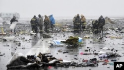 Russian Emergency Ministry employees investigate the wreckage of a crashed plane at the Rostov-on-Don airport, about 950 kilometers (600 miles) south of Moscow, March 19, 2016. 