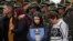 Relatives attend a ceremony marking one year since a car bomb attack on the police academy in Bogota, Colombia, Jan. 20, 2020.