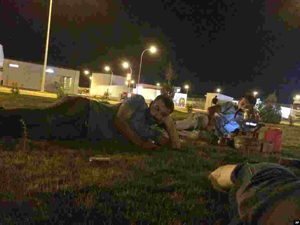 In this June 9, 2014 photo, Turkish truck drivers Ceyhun Ismaloglu (left) and Servet Karakan relax on the grounds of the Qayara Power Station in Iraq. The drivers were kidnapped by the Islamic State the following morning. The episode paints a picture of a militant group (IS) unusually careful not to anger Turkey&rsquo;s government - and offers insight into the mysterious release of 49 Turkish hostages in late September, 2014. 