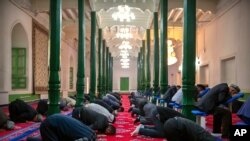 Uyghurs and other members of the faithful pray at the Id Kah Mosque in Kashgar in western China's Xinjiang Uyghur Autonomous Region, as seen during a government organized trip for foreign journalists, April 19, 2021.