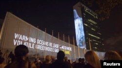 FILE - Messages on methane gas and carbon dioxide emissions are projected onto the United Nations building ahead of the climate change talks that will take place on the sidelines of the U.N. General Assembly, in New York, Sept. 20, 2014. 