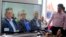 Former leaders of the Revolutionary Armed Forces of Colombia, FARC, Pablo Catatumbo, from left, Rodrigo London, and Carlos Antonio Lozada, are seen on a monitor, during a hearing of the peace tribunal in Bogota, Colombia, July 13, 2018. The FARC leaders have been summoned to the newly created special peace tribunal to respond to war crimes committed during the country's bloody five-decade conflict.