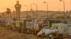 (FILE) Trucks of humanitarian aids wait to cross the Rafah border crossing between Egypt and the Gaza Strip, in Rafah, Egypt, Sept. 9, 2024.