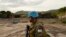 FILE - A UN soldier patrols the area surrounding the village of Kafe, at Lake Albert in Ituri, March 27, 2018. Conflict between members of the Lendu and Hema tribes has caused the instability within the Ituri region and thousands of Hema people to flee.