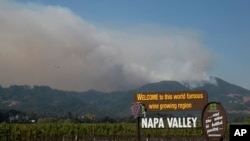FILE - Smoke billows from a fire burning in the mountains over Napa Valley, Friday, Oct. 13, 2017, in Oakville, Calif. (AP Photo/Rich Pedroncelli, File)
