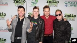 FILE - Eli Maiman, from left, Nicholas Petricca, Kevin Ray and Sean Waugaman of the band Walk the Moon pose for photographers.