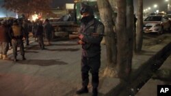 Afghan security forces stand guard near a terrorist attack site, close to the Spanish embassy, in center of Kabul, Afghanistan, Dec. 11, 2015. 