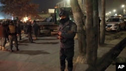 Afghan security forces stand guard near a terrorist attack site, close to the Spanish embassy, in center of Kabul, Afghanistan, Dec. 11, 2015. 