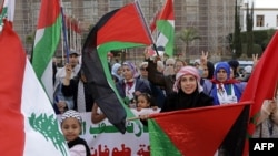 Demonstrators celebrate as they gather in front of the parliament building to express their support for the Palestinians, in Rabat on January 16, 2025, following the news of a ceasefire and hostage release deal between Hamas and Israel.