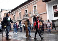 Demonstrators clash with riot police during a protest after Ecuadorian President Lenin Moreno's government ended four-decade-old fuel subsidies, in Quito, Ecuador, Oct. 3, 2019.