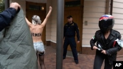 Activists of the Femen feminist group protest in front of the Iranian embassy in Kyiv, Ukraine, Oct. 4, 2024.