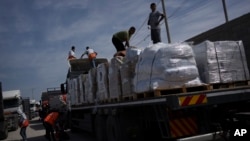 (FILE) Trucks with humanitarian aid for the 'Gaza Strip enter from Egypt.