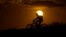 FILE - A cyclist tops a hill on a hot day at sunset, Aug. 20, 2023, in San Antonio. Scientists say 2023 will be the warmest in 125,000 years.