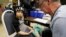 Registered Nurse Brian Jones draws a blood sample from Grayling Stefek, 5, at the Eisenhower Elementary School, in Flint, Mich., Jan. 26, 2016. The students were being tested for lead after the metal was found in the city's drinking water. 
