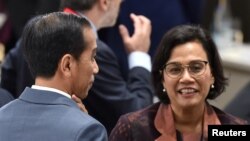 Presiden Joko Widodo (kiri) dan Menteri Keuangan RI Sri Mulyani Indrawati saat jeda pertemuan KTT G20, Osaka, Jepang, 29 Juni 2019. (Foto: dok).