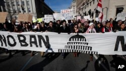 Protesters march from Lafayette Park near the White House in Washington, Feb. 4, 2017, during a rally protesting the immigration policies of President Donald Trump. 