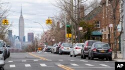 The Empire State building is seen in the distance from an empty street, April 2, 2020, in the Brooklyn borough of New York. 