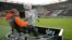 FILE - TV camera operator with the Sky television team checks his camera before a soccer match in Hamburg, August 28, 2010.
