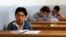 FILE - Students sit for their exam in what activists say is the only school in Hama not controlled by the Syrian regime, located in an area controlled by the Free Syrian Army, in Hama countryside, May 10, 2014. 