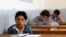 FILE - Students are seen taking exams in Hama, Syria, May 10, 2014. 