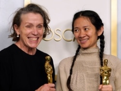 Producers Frances McDormand, left, and Chloe Zhao, winners of the award for best picture for "Nomadland," pose in the press room at the Oscars on Sunday, April 25, 2021, at Union Station in Los Angeles. (AP Photo/Chris Pizzello, Pool)