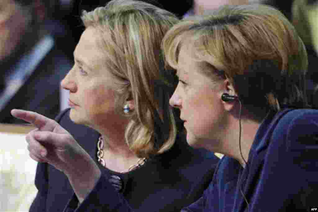 U.S. Secretary of State Hillary Rodham Clinton, left, looks as German Chancellor Angela Merkel points at something at the start of the OSCE Summit at the Palace of Independence in Astana, Kazakhstan, Wednesday Dec. 1, 2010. The OSCE Summit, the first ever