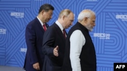 Chinese President Xi Jinping, Russian President Vladimir Putin and Indian Prime Minister Narendra Modi arrive for a photo during the BRICS summit in Kazan, Russia, on Oct. 23, 2024.