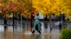 A pedestrian walks along a flooded street during a storm Nov. 21, 2024, in Santa Rosa, Calif.